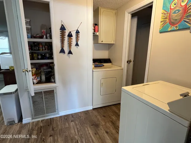 a room with a white cabinets and washer