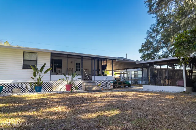 a front view of house with yard outdoor seating and barbeque oven