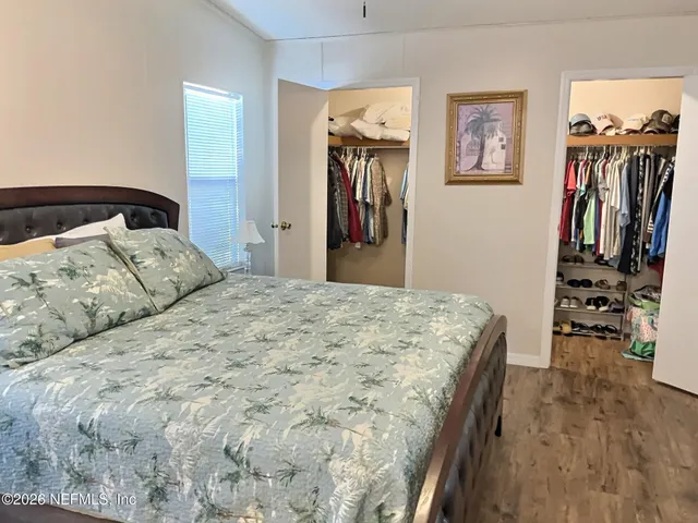 a bedroom with a bed and a walk in closet