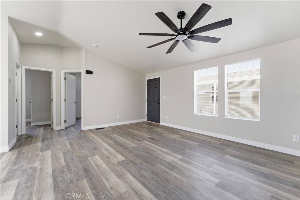20843 Waalew Road, Unit C125 Apple Valley, CA 92307 - Photo 21 of 38 a view of empty room with wooden floor and ceiling fan