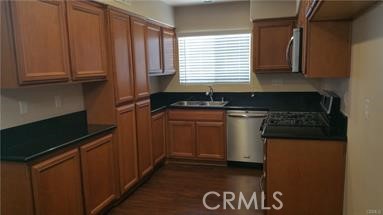 1510 Orange Avenue, Unit 205 Redlands, CA 92373 - Photo 9 of 27 a kitchen with granite countertop a stove a sink and a microwave