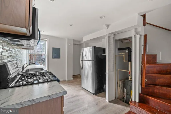 a kitchen with stainless steel appliances granite countertop a stove and a microwave