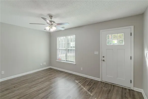 wooden floor in an empty room with a window
