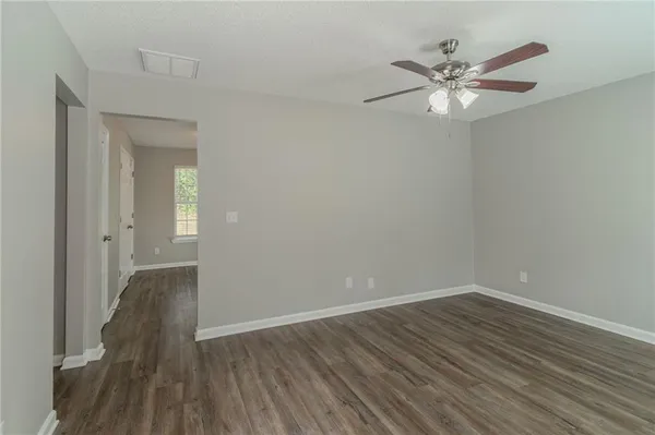 a view of a hallway with wooden floor and closet