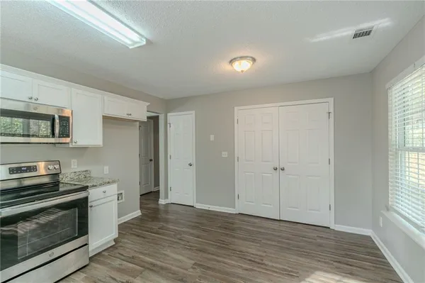a kitchen with granite countertop a stove and a refrigerator
