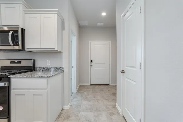 a kitchen with stainless steel appliances granite countertop a stove and a refrigerator