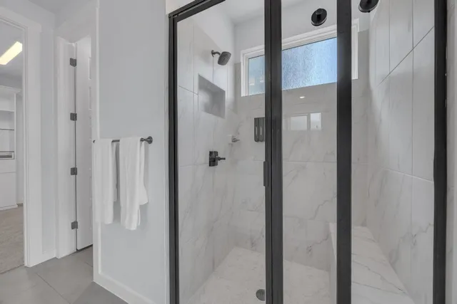 a spacious bedroom with a bed and ceiling fan