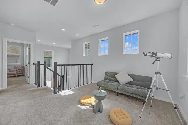 a very nice looking living room with a large window and wooden floor