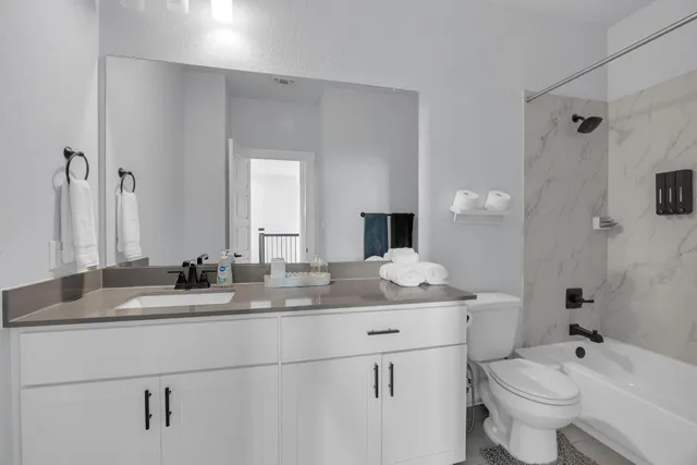 a bedroom with a bed and a lamp