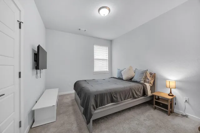 a bathroom with a granite countertop sink a toilet and a mirror