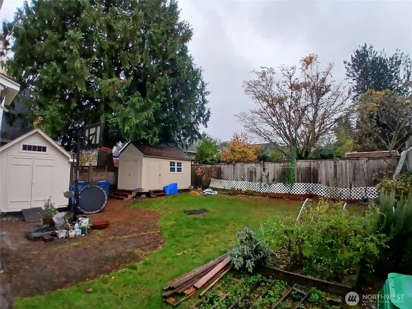 a view of a backyard with a garden and trees