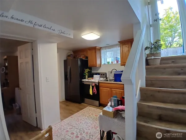 a view of entryway kitchen and wooden floor