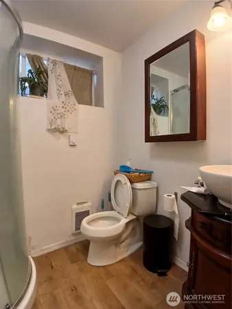 a bathroom with a toilet a sink and a mirror