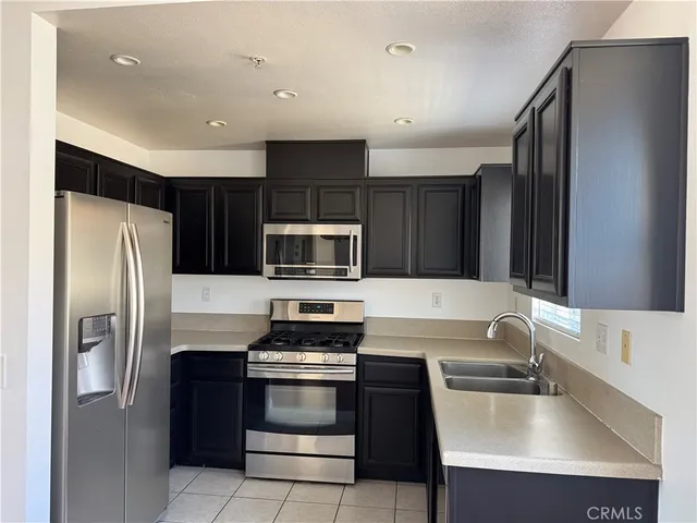 a kitchen with a refrigerator sink and microwave