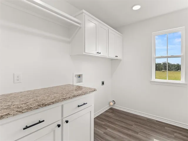 an empty room with windows and ceiling fan