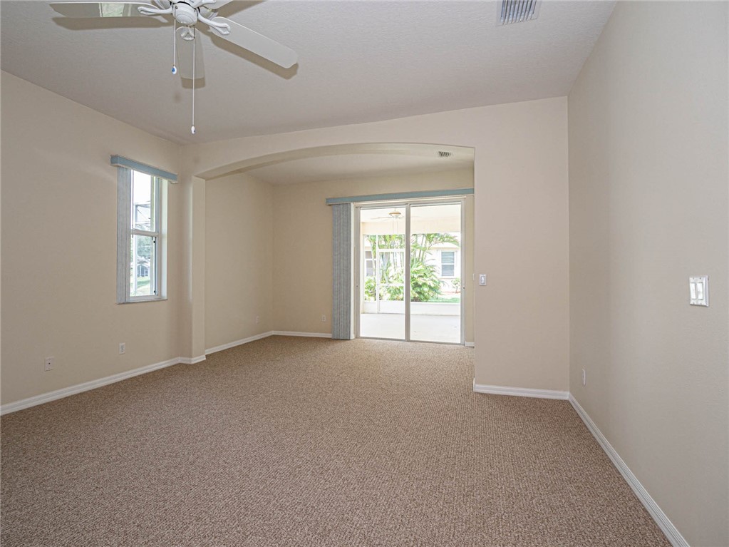 1422 Tradewinds Way Sebastian, FL 32958 - Photo 15 of 35 an empty room with a window and a fan