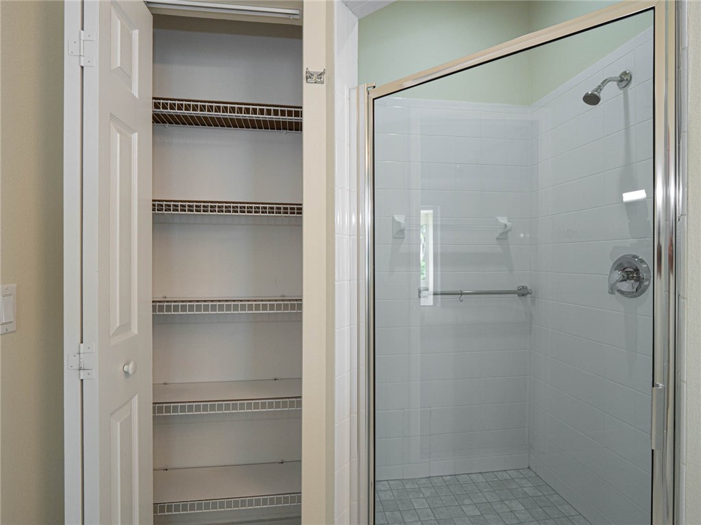 1422 Tradewinds Way Sebastian, FL 32958 - Photo 19 of 35 a bathroom with a glass shower door