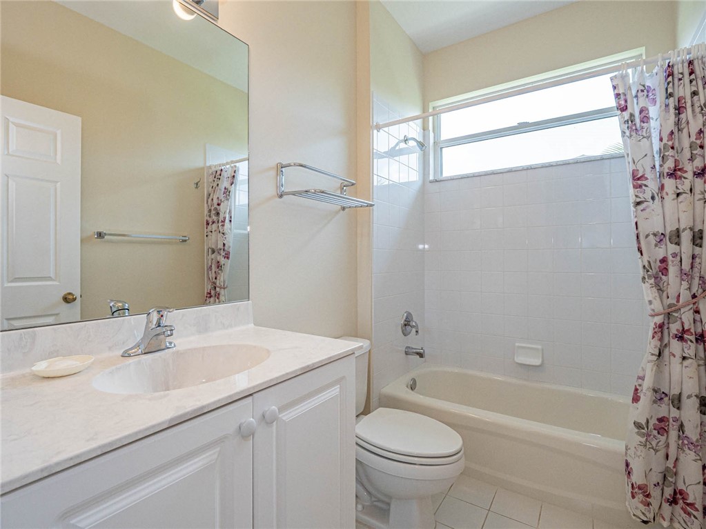 1422 Tradewinds Way Sebastian, FL 32958 - Photo 21 of 35 a bathroom with a sink a toilet a bathtub and shower