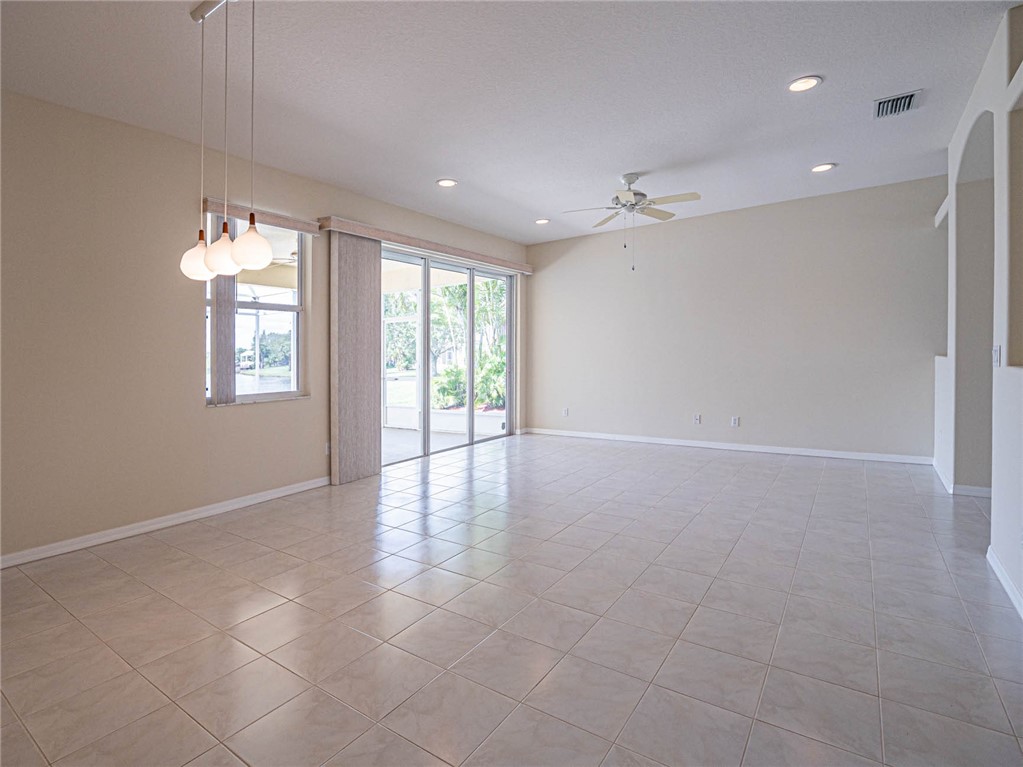 1422 Tradewinds Way Sebastian, FL 32958 - Photo 6 of 35 an empty room with windows and ceiling fan