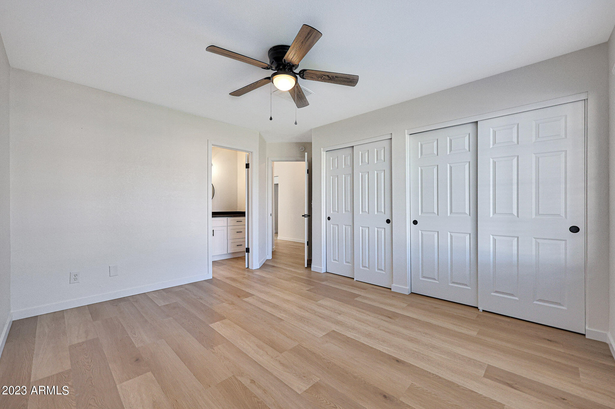 613 West Rosemonte Drive Phoenix, AZ 85027 - Photo 11 of 24 a view of a livingroom with a chandelier fan and wooden floor