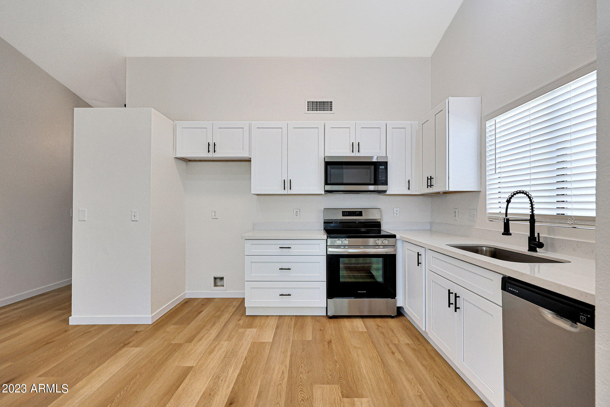 613 West Rosemonte Drive Phoenix, AZ 85027 - Photo 20 of 24 a kitchen with a sink stove and cabinets