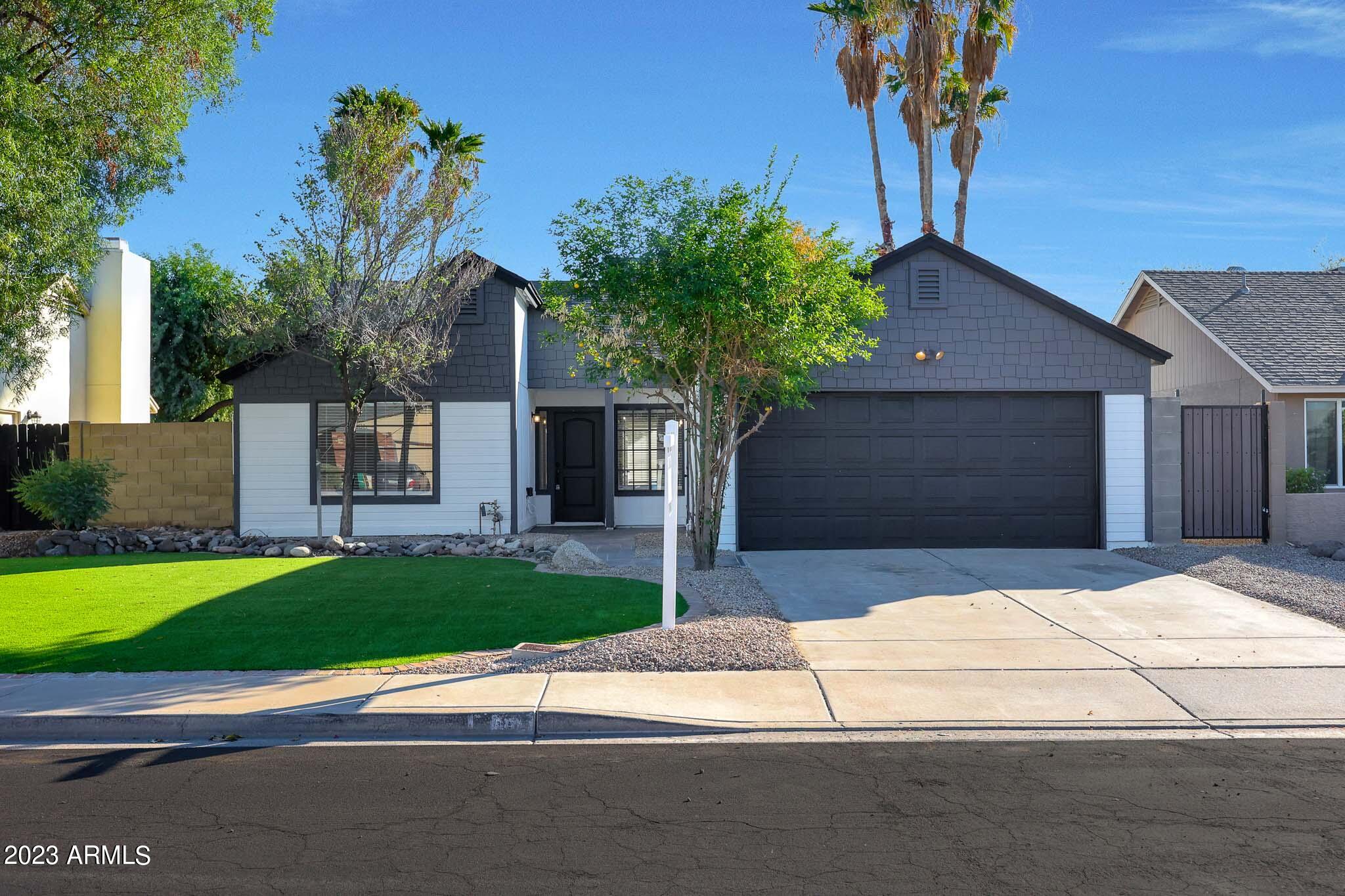 613 West Rosemonte Drive Phoenix, AZ 85027 - Photo 2 of 24 a house with tree in front of it