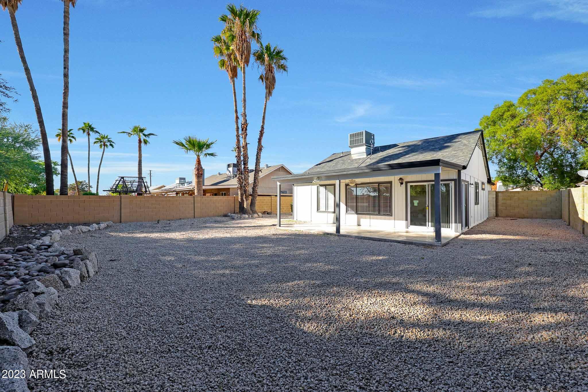 613 West Rosemonte Drive Phoenix, AZ 85027 - Photo 23 of 24 a front view of a house with a yard and garage