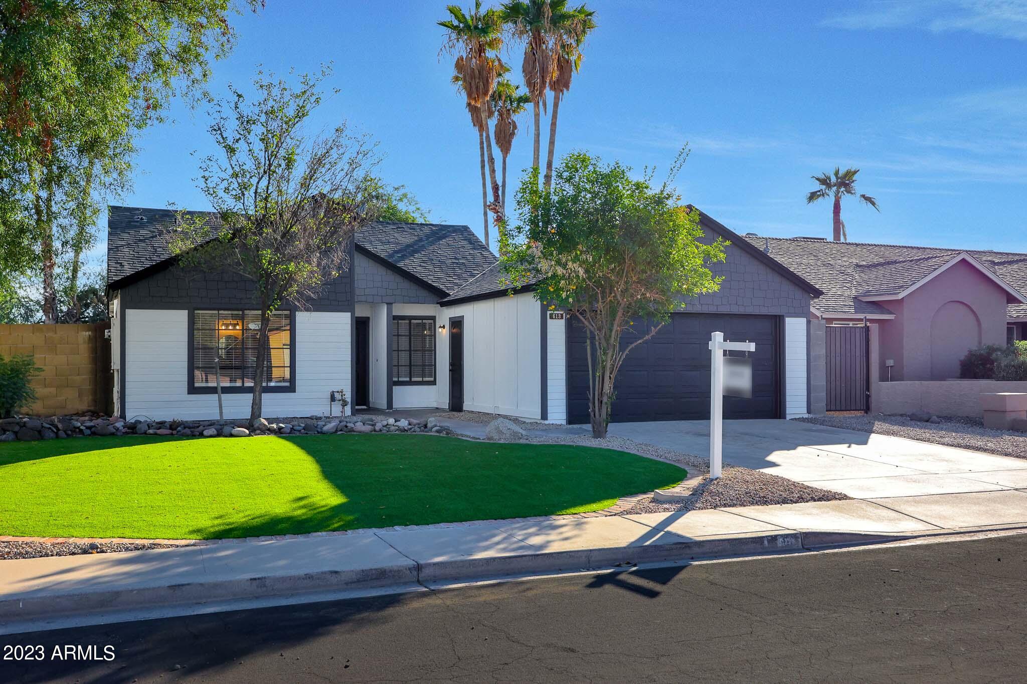 613 West Rosemonte Drive Phoenix, AZ 85027 - Photo 3 of 24 a house that has a tree in front of it