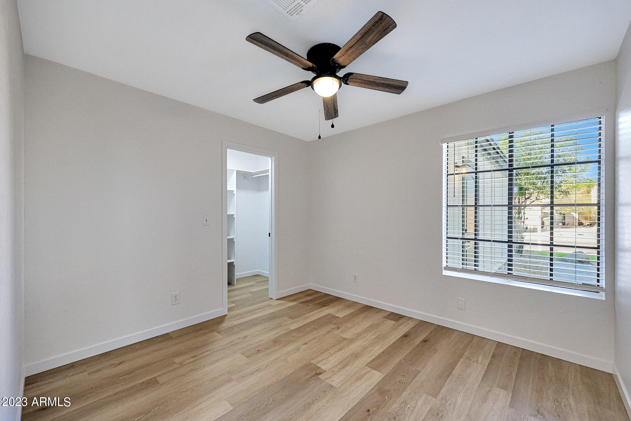 613 West Rosemonte Drive Phoenix, AZ 85027 - Photo 4 of 24 wooden floor in an empty room with a window