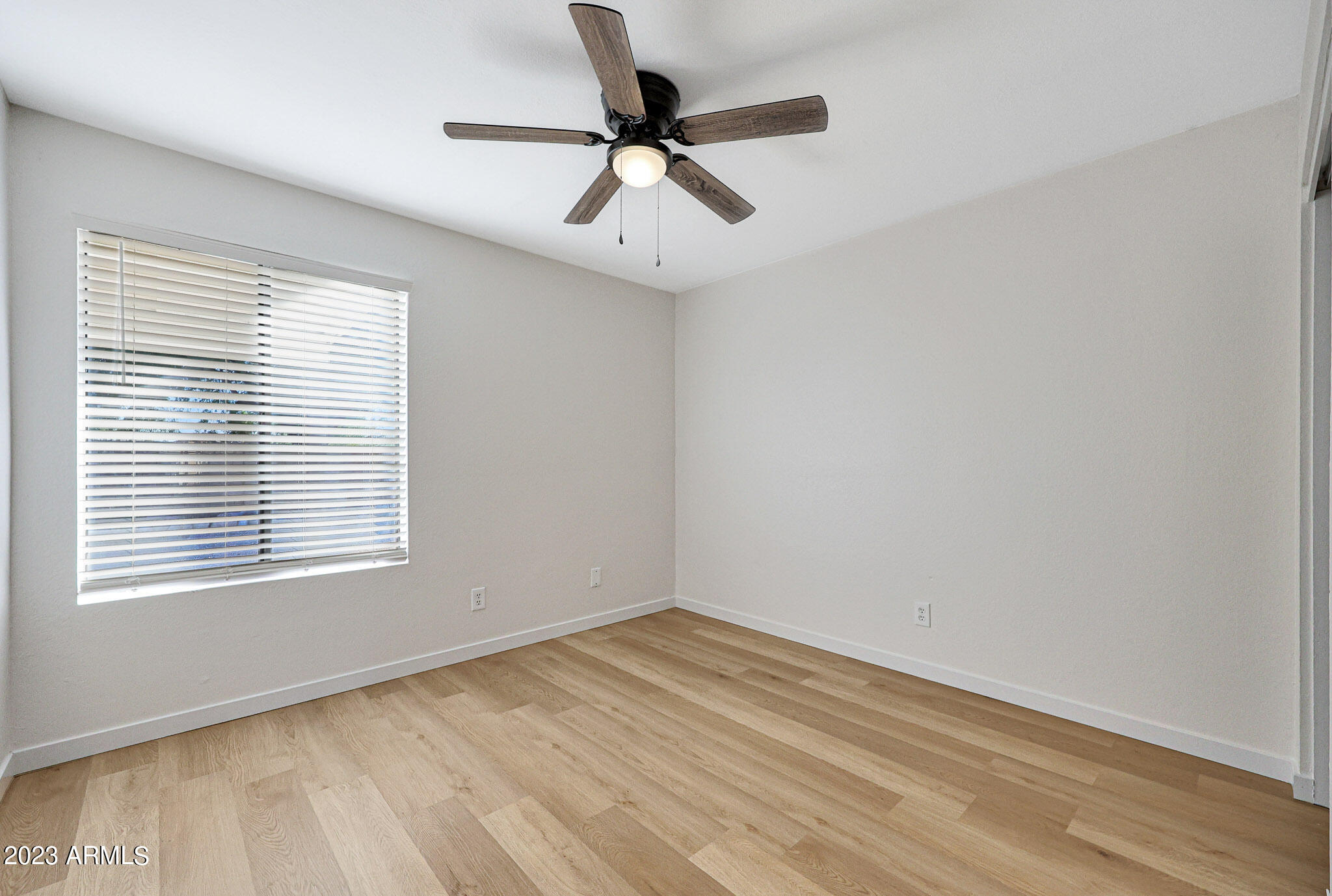 613 West Rosemonte Drive Phoenix, AZ 85027 - Photo 7 of 24 wooden floor in an empty room with a window
