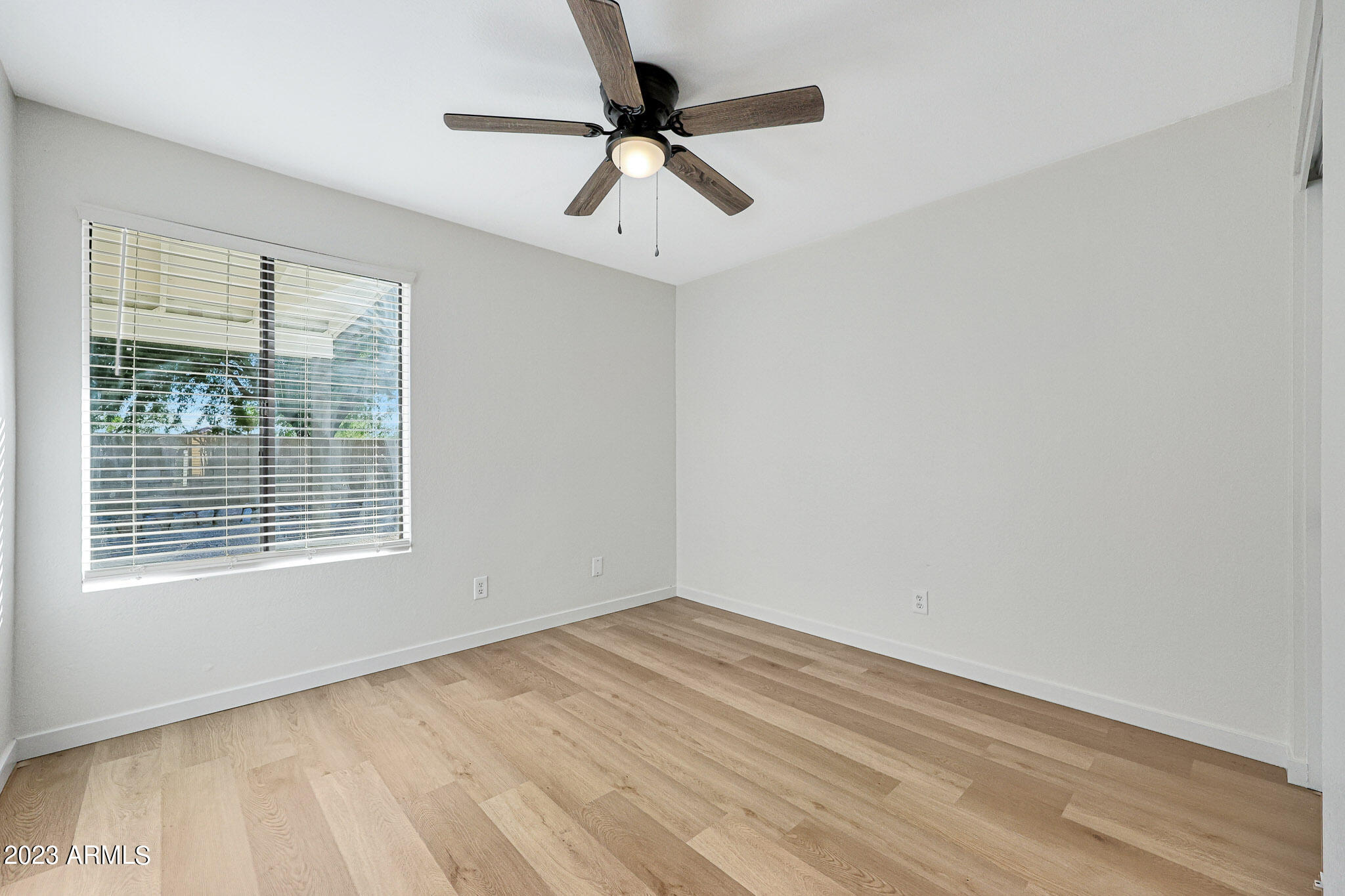 613 West Rosemonte Drive Phoenix, AZ 85027 - Photo 8 of 24 a view of an empty room with a window and a ceiling fan
