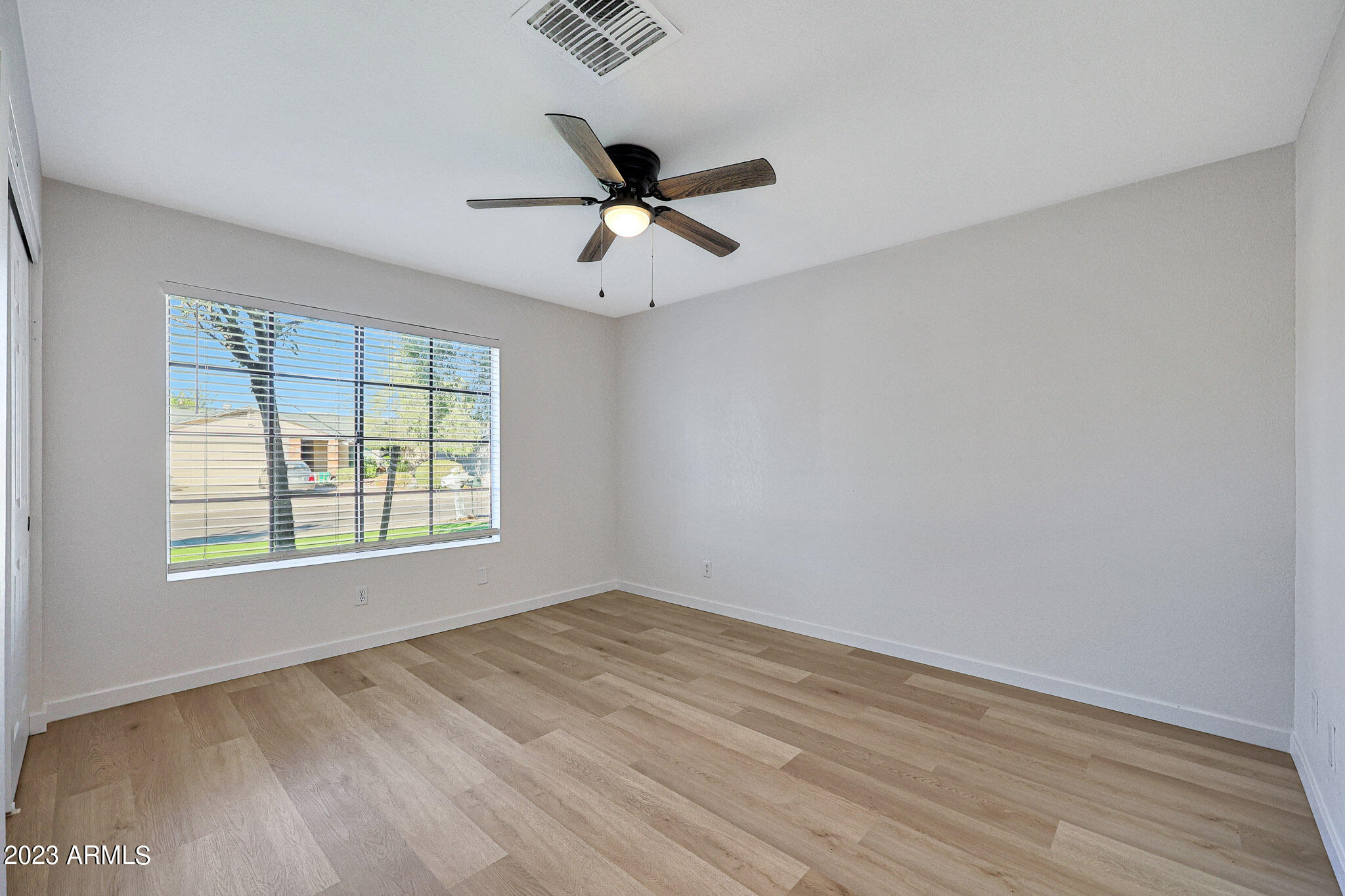 613 West Rosemonte Drive Phoenix, AZ 85027 - Photo 10 of 24 wooden floor in an empty room with a window