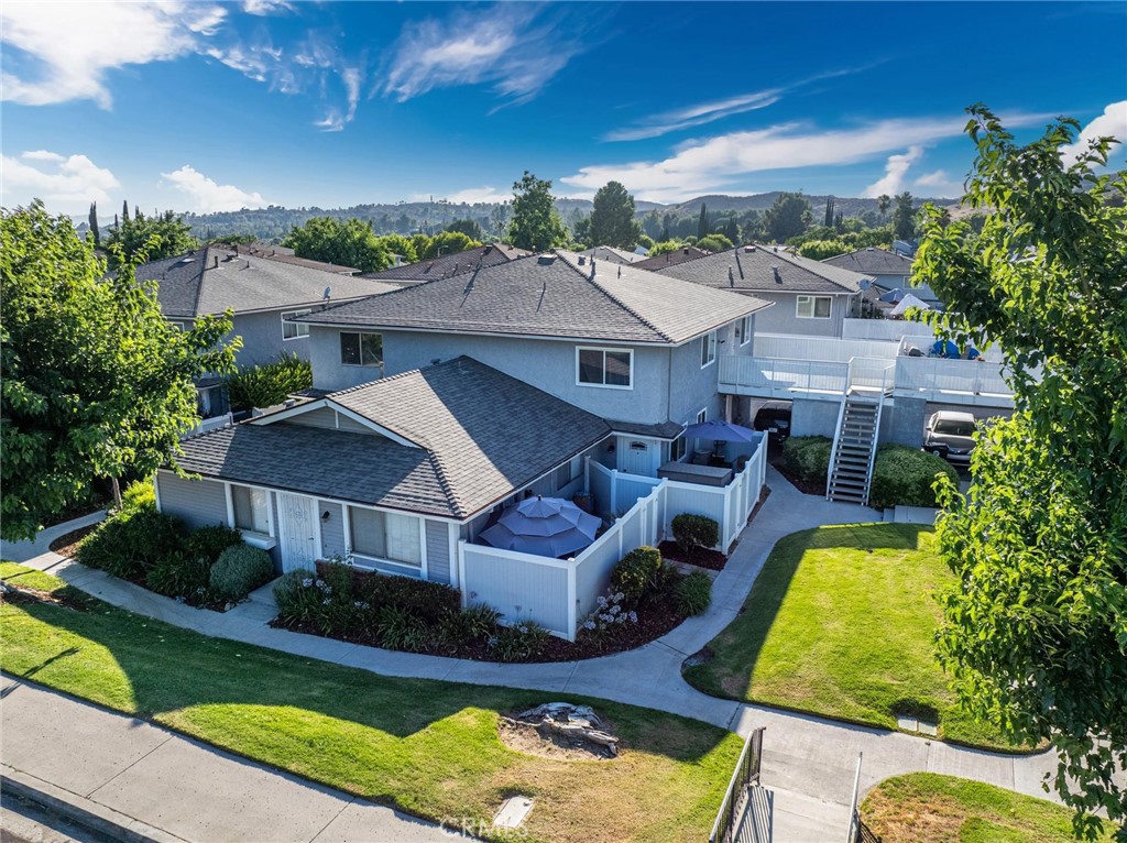 an aerial view of a house with swimming pool garden and patio