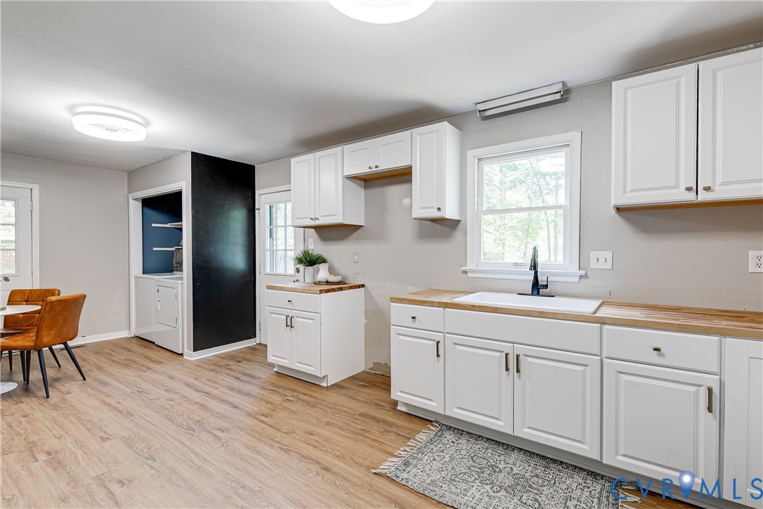 11211 Moravia Road Midlothian, VA 23112 - Photo 11 of 40 a kitchen with white cabinets and sink