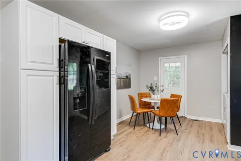 a dining room with furniture and wooden floor