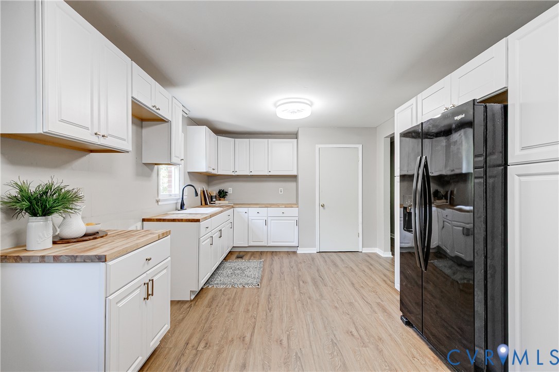 11211 Moravia Road Midlothian, VA 23112 - Photo 14 of 40 a kitchen with white cabinets and appliances