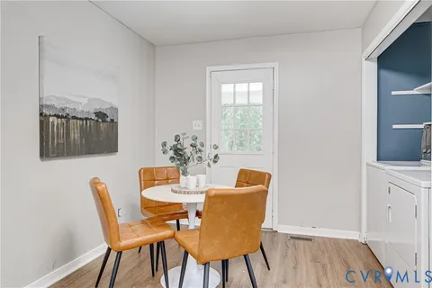 a dining room with furniture and wooden floor