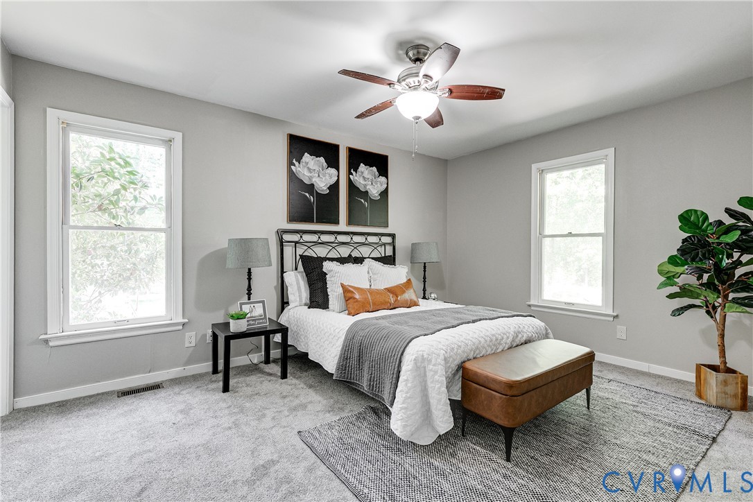 11211 Moravia Road Midlothian, VA 23112 - Photo 24 of 40 a bedroom with a bed and a chandelier