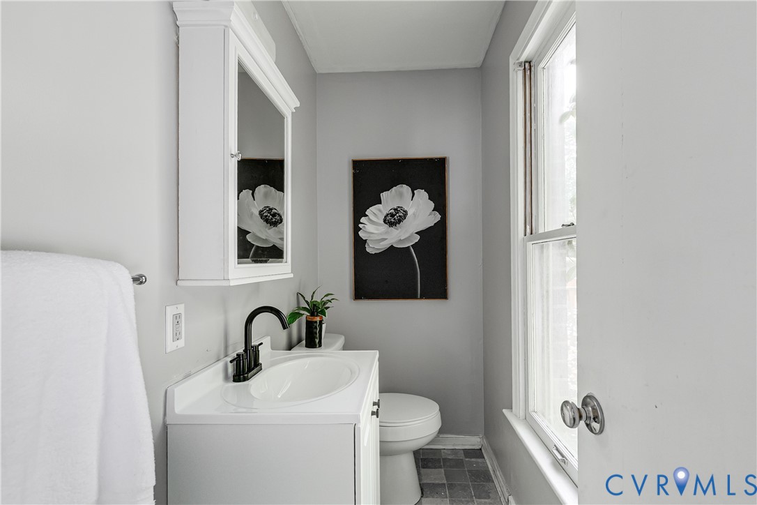 11211 Moravia Road Midlothian, VA 23112 - Photo 26 of 40 a bathroom with a toilet sink and mirror