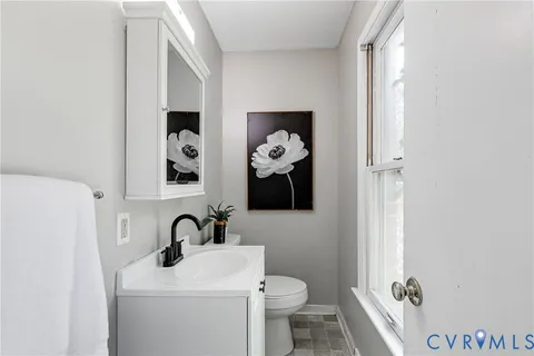 a bathroom with a toilet sink and mirror