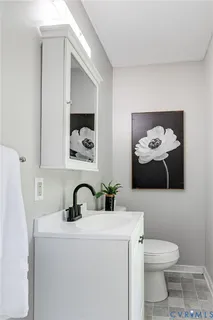 a bathroom with a sink and mirror with toilet