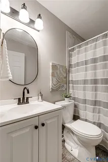 a bathroom with a sink toilet and mirror