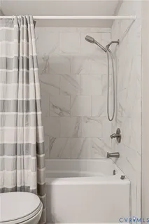 a bathroom with a shower and a toilet