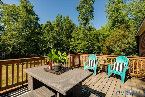 a view of a deck with furniture and trees