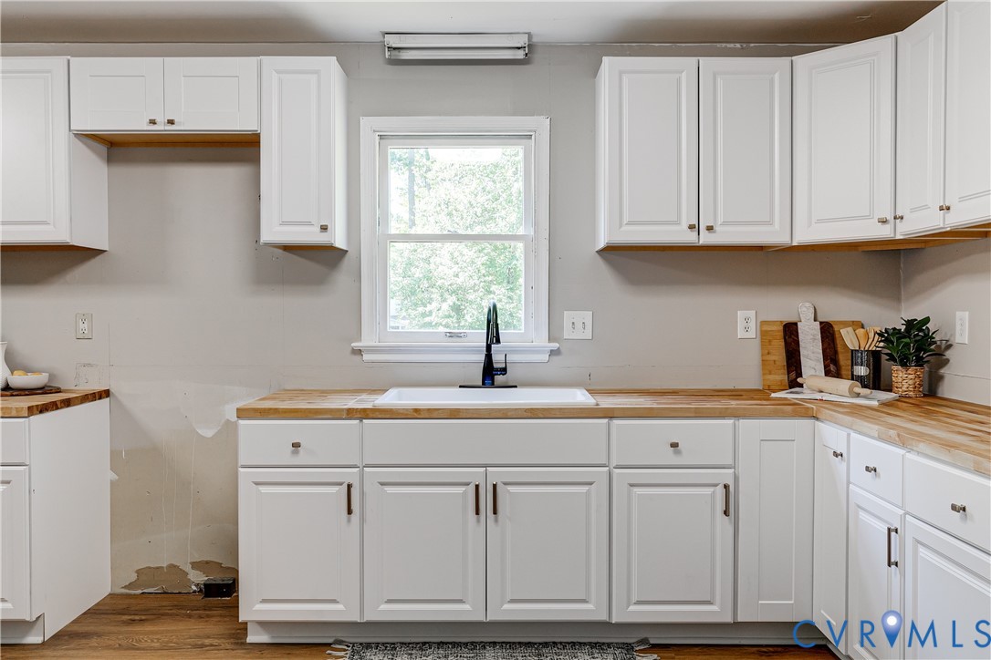 11211 Moravia Road Midlothian, VA 23112 - Photo 10 of 40 a kitchen with white cabinets and white appliances
