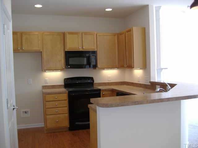 8304 Pilots View Drive, Unit 24 Raleigh, NC 27617 - Photo 4 of 10 Recessed lighting, under the cabinet lights, and bar stool ledge Other