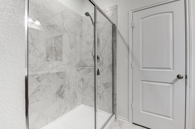 1237 Volente Lane Leander, TX 78641 - Photo 16 of 22 A well-appointed shower stall, clad in elegant tile, offers a refreshing bathing experience.