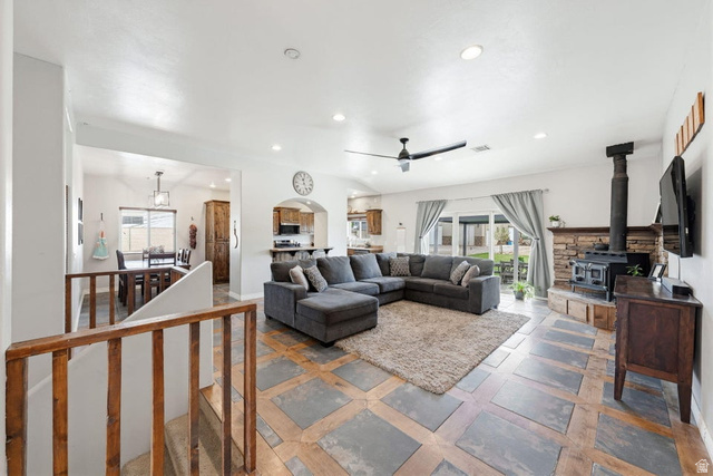 7776 Wagon Road East St. George, UT 84770 - Photo 8 of 76 Living area with recessed lighting, a wood stove, healthy amount of natural light, and ceiling fan