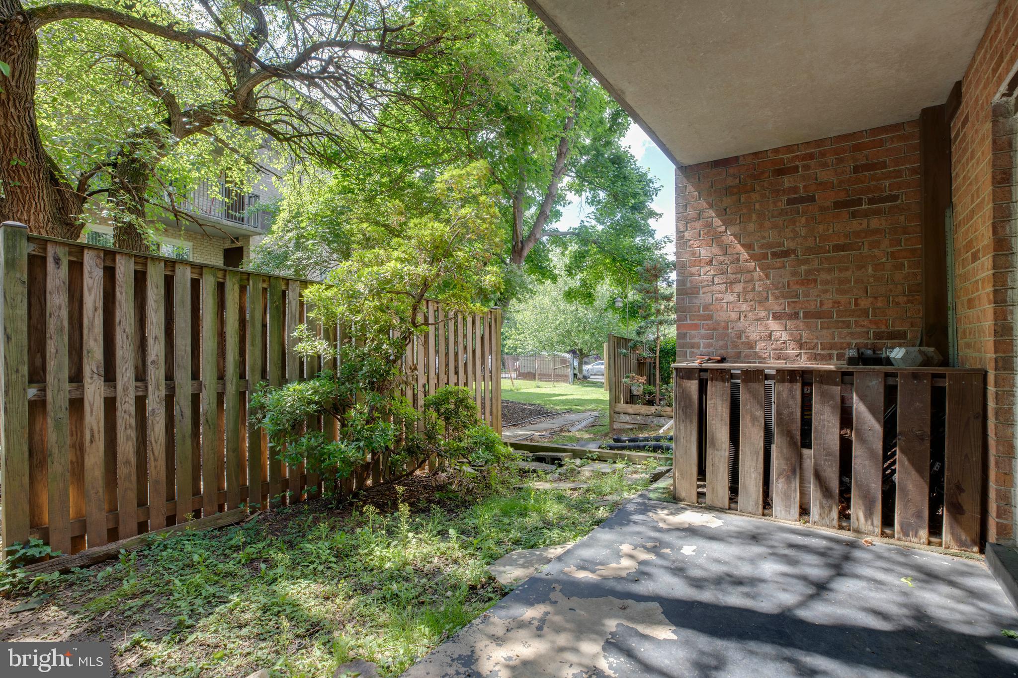 3382 Hewitt Avenue, Unit 102 Silver Spring, MD 20906 - Photo 17 of 22 a view of backyard with potted plants and wooden fence