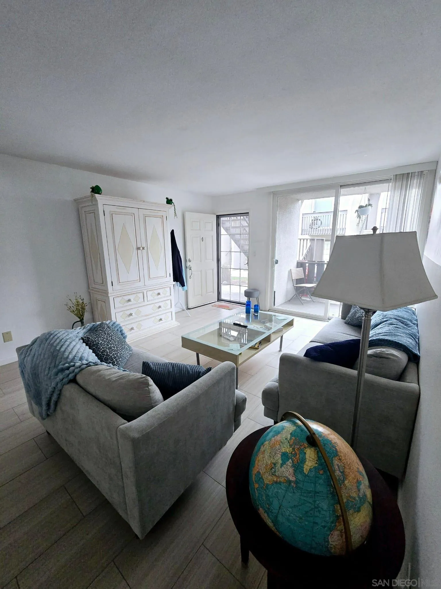 6333 Mt Ada Road, Unit 168 San Diego, CA 92111 - Photo 12 of 23 a living room with furniture and a large window